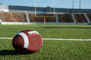 American football with goal in background: Vision, Goal, Unified Team, Leadership